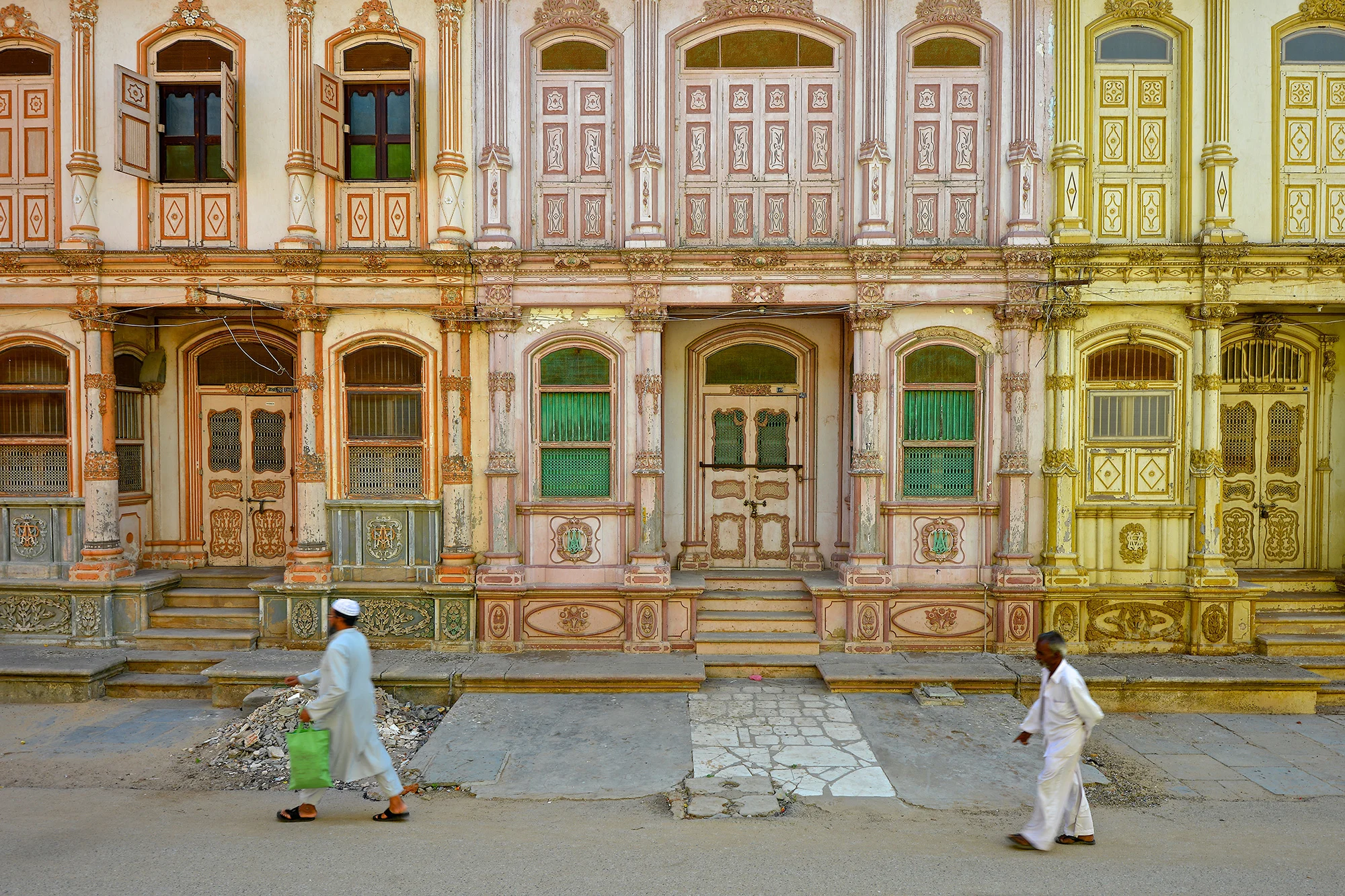 The dusty highway leading to Sidhpur, in western India’s Gujarat state, winds through arid landscapes past roadside eateries and herds of lumbering camel, offering little hint of what the historic town holds. In the heart of Sidhpur lies a street lined with stately three- and four-story mansions, known as “havelis,” in a fading palette of rainbow pastel shades, from teal and baby pink to pistachio green. Known locally as Paris Galli, or Paris Street, it transports visitors to a European city with grand Neoclassical architecture and a harmonious melange of Art Deco, Baroque and hybrid Indian styles.